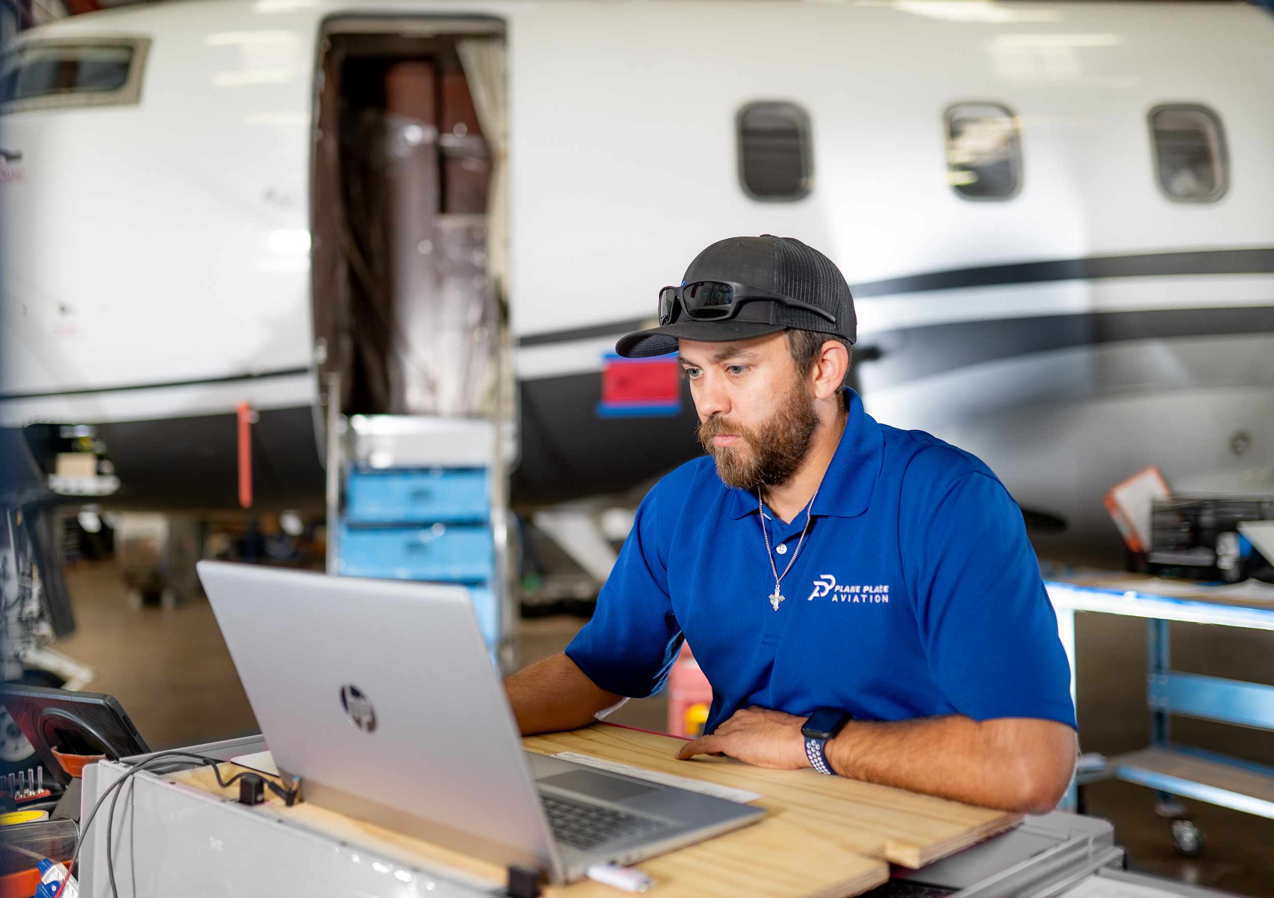 Plane Place Aviation technician working on a Challenger component at the maintenance workstation